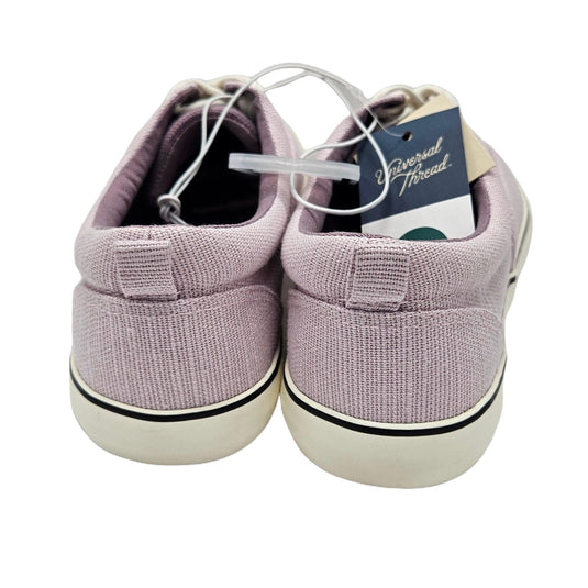 Close-up back view of women's light lavender vulcanized canvas sneakers with white laces and rubber sole